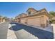 Exterior view of townhomes with private garages and manicured landscaping at 6745 Caporetto Ln # 104, North Las Vegas, NV 89084