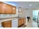 Stylish kitchen with stainless steel appliances, tile backsplash, and light wood cabinetry at 6745 Caporetto Ln # 104, North Las Vegas, NV 89084