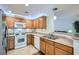 Modern kitchen with stainless steel appliances, tile backsplash, and light wood cabinetry at 6745 Caporetto Ln # 104, North Las Vegas, NV 89084