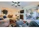 Comfortable living room with ceiling fan, sliding door access to patio, and adjacent dining area at 6745 Caporetto Ln # 104, North Las Vegas, NV 89084