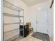 A simple mud room featuring shelving, storage, and tiled floors at 6745 Caporetto Ln # 104, North Las Vegas, NV 89084
