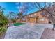 Large backyard featuring a covered patio, grass, pavers, and a two-story home at 7479 Lassen Peak Cir, Las Vegas, NV 89149