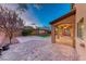 Backyard with covered patio, brick pavers, grass, and low-maintenance landscaping at 7479 Lassen Peak Cir, Las Vegas, NV 89149