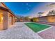 Backyard featuring a covered patio, grass, pavers, and desert landscaping at 7479 Lassen Peak Cir, Las Vegas, NV 89149