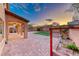 Backyard patio area with a patch of grass and brick pavers at 7479 Lassen Peak Cir, Las Vegas, NV 89149