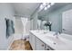 Bathroom with double sinks, tile flooring, and white cabinets at 7479 Lassen Peak Cir, Las Vegas, NV 89149