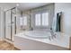 Bathroom with a glass-enclosed shower and soaking tub provides relaxation and convenience at 7479 Lassen Peak Cir, Las Vegas, NV 89149