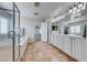 Well-lit bathroom with a double vanity, tub, and glass-enclosed shower offering a clean and modern feel at 7479 Lassen Peak Cir, Las Vegas, NV 89149