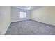 Spacious bedroom with neutral walls, plush carpeting, and a ceiling fan for comfort at 7479 Lassen Peak Cir, Las Vegas, NV 89149
