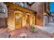 Inviting front entrance featuring a stone archway, desert landscaping, and a three-car garage at 7479 Lassen Peak Cir, Las Vegas, NV 89149