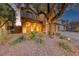 Beautiful front yard with manicured desert landscaping featuring a stone archway and terracotta roofing at 7479 Lassen Peak Cir, Las Vegas, NV 89149