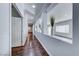 Hallway with hardwood floors and decorative wall niches leading to the living areas at 7479 Lassen Peak Cir, Las Vegas, NV 89149