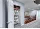 Upstairs hallway and closet with white shelving for storage with an American flag and towels at 7479 Lassen Peak Cir, Las Vegas, NV 89149