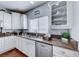 Well-lit kitchen featuring white cabinets, stainless steel appliances, and granite countertops at 7479 Lassen Peak Cir, Las Vegas, NV 89149