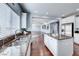 Bright kitchen with granite counters, stainless steel sink, and a view to the living room at 7479 Lassen Peak Cir, Las Vegas, NV 89149