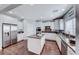 Modern kitchen with white cabinets, stainless steel appliances, and a granite island with seating at 7479 Lassen Peak Cir, Las Vegas, NV 89149