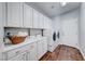 Well-equipped laundry room featuring white cabinets, sink, and washer/dryer units at 7479 Lassen Peak Cir, Las Vegas, NV 89149