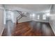 Bright living room with wood floors, staircase, and ample natural light from the windows at 7479 Lassen Peak Cir, Las Vegas, NV 89149