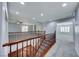 Open loft area with carpet, showcasing a wood railing and views into adjacent rooms at 7479 Lassen Peak Cir, Las Vegas, NV 89149