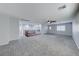 Expansive carpeted loft with a ceiling fan and natural light, perfect for entertaining at 7479 Lassen Peak Cir, Las Vegas, NV 89149