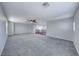 Large carpeted loft, featuring bright natural light and a ceiling fan for comfort at 7479 Lassen Peak Cir, Las Vegas, NV 89149