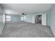 A spacious carpeted loft featuring a ceiling fan, ample light, and access to multiple rooms at 7479 Lassen Peak Cir, Las Vegas, NV 89149