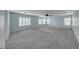 Bright loft area with carpet, large windows with shutters, and neutral paint at 7479 Lassen Peak Cir, Las Vegas, NV 89149