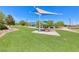 Picnic table with sunshade offers a comfortable space for outdoor dining and Gathering gatherings at 7479 Lassen Peak Cir, Las Vegas, NV 89149