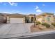 Charming single-story home featuring a tile roof, desert landscaping, and a two-car garage in a quiet community at 8220 Weeping Springs Ave, Las Vegas, NV 89131