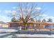 Charming single-story home featuring a gated front yard and neutral-tone exterior, topped by a vibrant blue, cloud filled sky at 849 Parkhurst St, Las Vegas, NV 89110