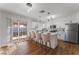 Modern kitchen featuring white cabinetry, quartz countertops, stainless steel appliances, and a stylish breakfast bar at 849 Parkhurst St, Las Vegas, NV 89110