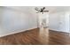 Bright living room featuring wood-look floors, a ceiling fan, and a seamless transition to the adjacent kitchen at 849 Parkhurst St, Las Vegas, NV 89110