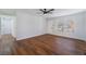 Spacious living area featuring wood-look floors, white walls, and natural light from a large window at 849 Parkhurst St, Las Vegas, NV 89110