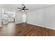 Open-concept space featuring wood-look floors, a ceiling fan, and views into the kitchen with an eat-in breakfast bar at 849 Parkhurst St, Las Vegas, NV 89110