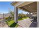 Covered patio provides shade, complete with an outdoor dining area and view of the landscaped yard at 912 Calluna Hills Ln, Las Vegas, NV 89138