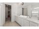Elegant bathroom featuring a long vanity with double sinks, a glass-enclosed shower, and modern finishes at 912 Calluna Hills Ln, Las Vegas, NV 89138