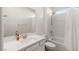 Modern bathroom features sleek white fixtures, a shower-tub combo, and a vanity with ample counter space at 912 Calluna Hills Ln, Las Vegas, NV 89138