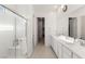 Spacious bathroom boasts a glass-enclosed shower, double sinks, and a long vanity with sleek countertops at 912 Calluna Hills Ln, Las Vegas, NV 89138