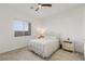 Bright, airy bedroom with a ceiling fan, a plush carpet, and ample natural light from the large window at 912 Calluna Hills Ln, Las Vegas, NV 89138