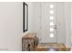 Bright entryway showcasing a modern door with glass inserts and a rustic wood console table at 912 Calluna Hills Ln, Las Vegas, NV 89138