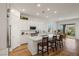 Stylish kitchen with white cabinets, quartz countertops, an island with seating, and modern appliances at 912 Calluna Hills Ln, Las Vegas, NV 89138