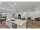 Bright, open-concept kitchen with stainless steel appliances and a large center island that flows into the living area at 912 Calluna Hills Ln, Las Vegas, NV 89138
