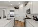 Well-lit kitchen with white cabinets, stainless steel appliances, and a view into an adjacent dining area at 912 Calluna Hills Ln, Las Vegas, NV 89138