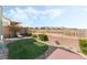 Private backyard featuring artificial turf, desert landscaping, and mountain views at 9130 Haddington Ln, Las Vegas, NV 89145