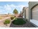 Home's backyard features artificial turf, a patio, and views of nearby city buildings at 9130 Haddington Ln, Las Vegas, NV 89145