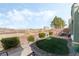 Backyard featuring a patio with outdoor seating, artificial turf, and desert landscaping at 9130 Haddington Ln, Las Vegas, NV 89145