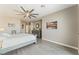 Bright bedroom with a ceiling fan, wood-look flooring, and a large dresser for ample storage at 9130 Haddington Ln, Las Vegas, NV 89145