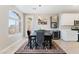Cozy dining area featuring a modern light fixture, a wine cooler, and tile flooring at 9130 Haddington Ln, Las Vegas, NV 89145