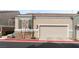 Charming neutral stucco home with a two car garage and green shutters on the front window at 9130 Haddington Ln, Las Vegas, NV 89145