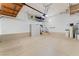 Spacious garage with high ceilings, storage cabinets, and stairs to interior at 9130 Haddington Ln, Las Vegas, NV 89145